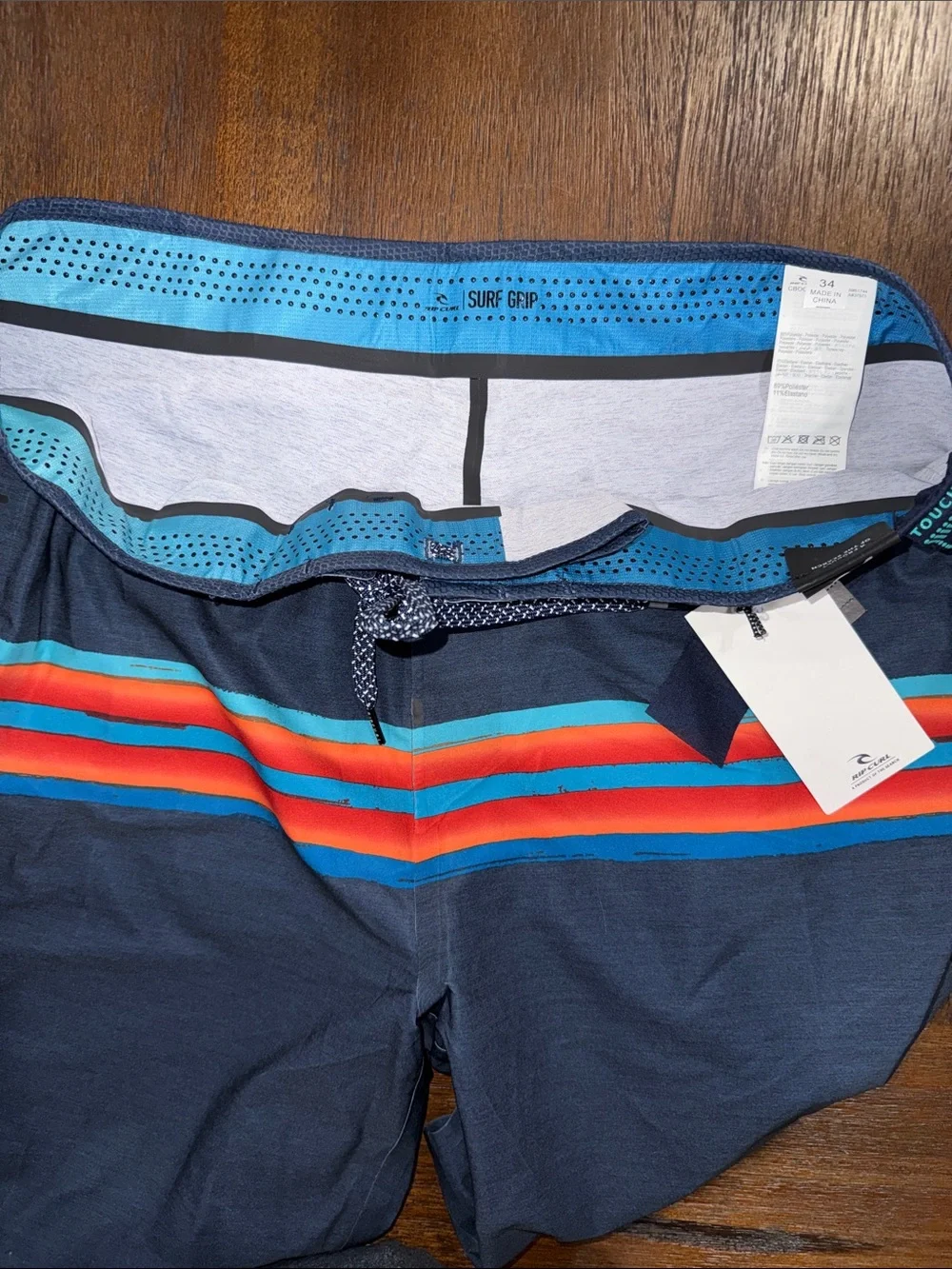Rip Curl Mirage Mick Fanning Navy Board Shorts with Red & Aqua Stripes 34